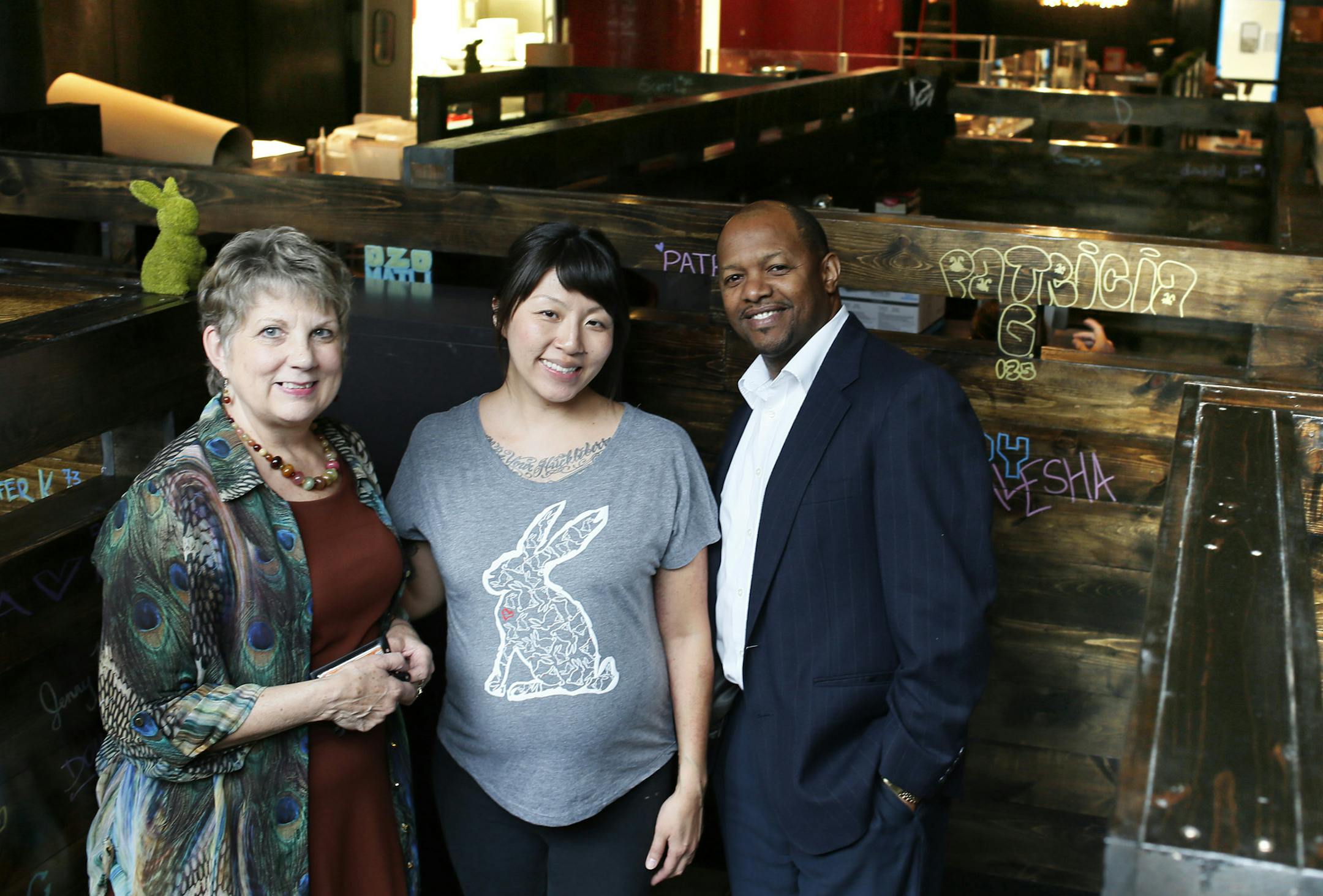 Kat Kim center (owner) of The Rabbit Hole posed for a photo with Becky George left and Earlsworth "Baba" Letang of the Midtown global Market management team. ] JERRY HOLT ‚Äö√Ñ¬¢ jerry.holt@startribune.com ORG XMIT: MIN1310151554396634