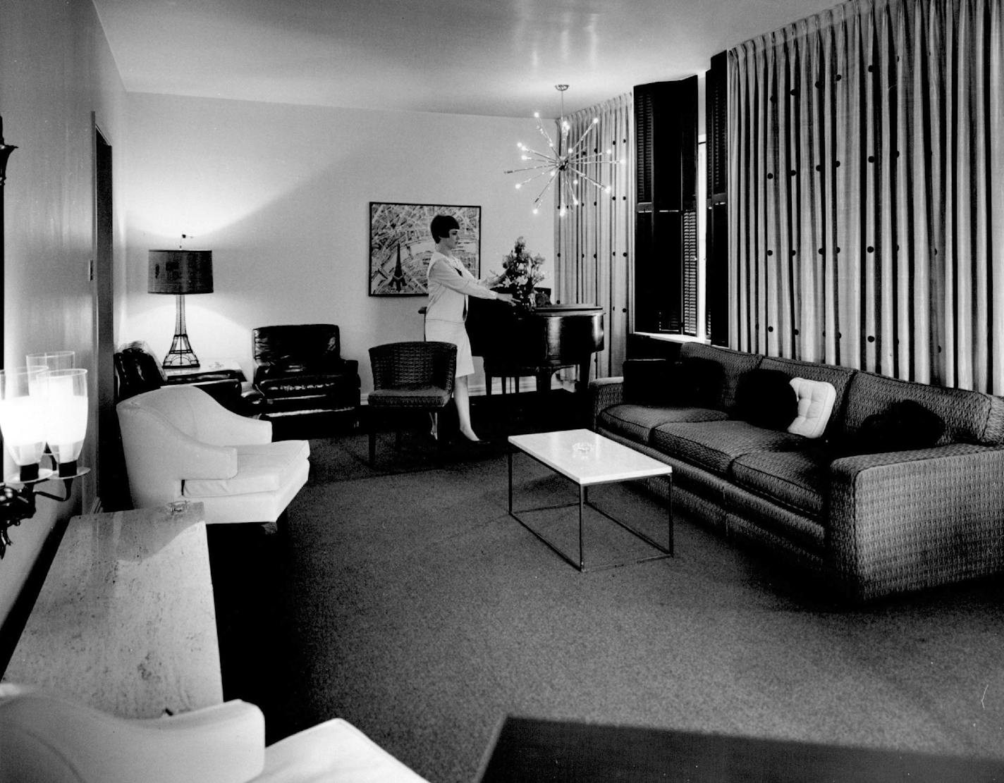 September 24, 1967 The Albert Pick Suite at the Pick Nicollet Hotel in downtown Minneapolis costs $70 per day and includes a large parlor, master bedroom, a second bedroom and two tile bathrooms. The parlor (above) has off-white walls, red carpeting and black shutters. The furnishings in the room include marble-topped coffee tables and desk, a baby grand piano and several leather chairs. The suite is used by corporation presidents, politicians, convention officials and entertainers. Picture Maga