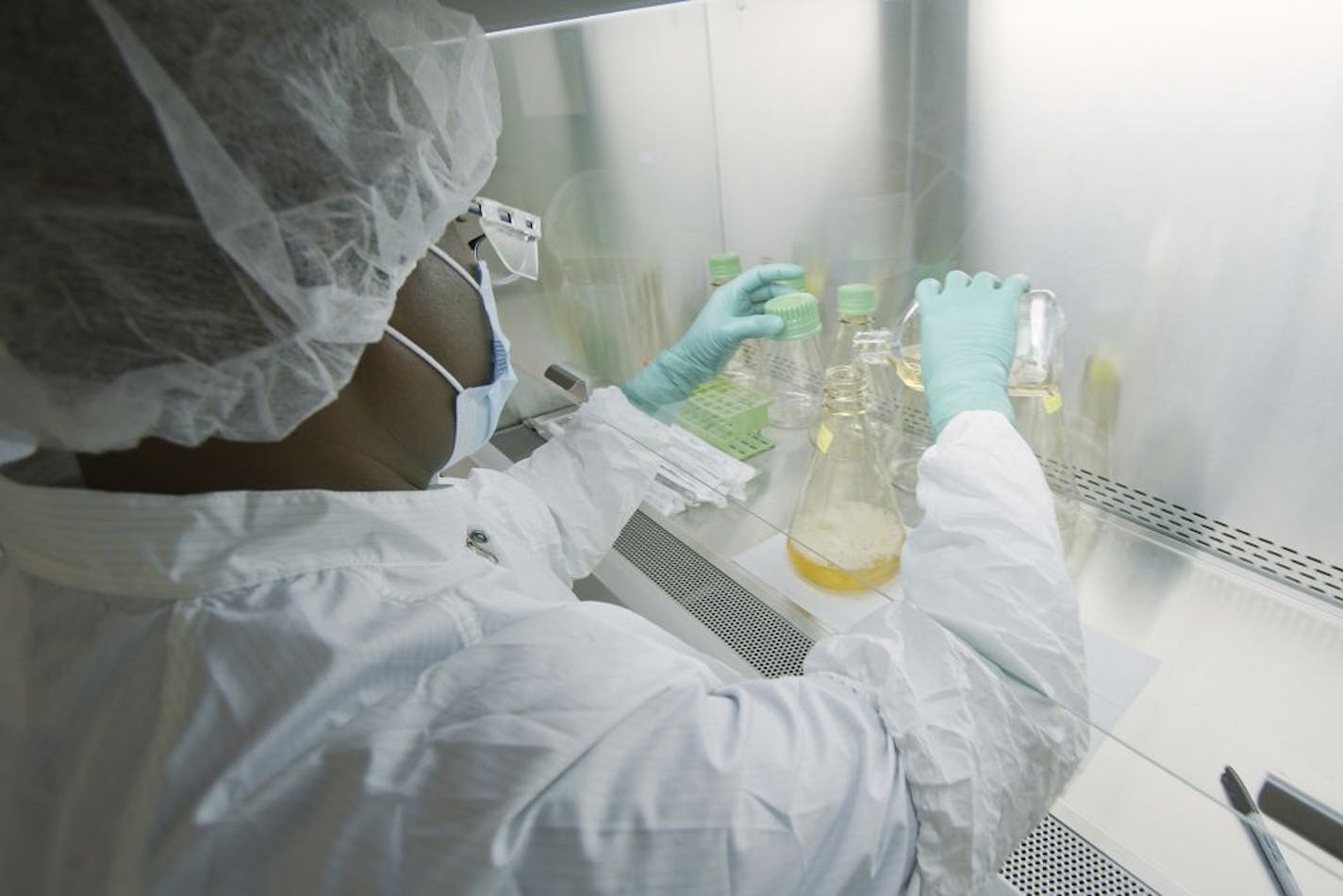 In this May 2020 file photo provided by Eli Lilly, a researcher tests possible COVID-19 antibodies in a laboratory in Indianapolis. The FDA on Monday cleared the experimental antibody treatment drug from Eli Lilly for people 12 and older with mild or moderate COVID-19 not requiring hospitalization.