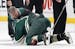 Zach Parise (11) was hit in the face with a high stick by Tom Wilson in the first period.