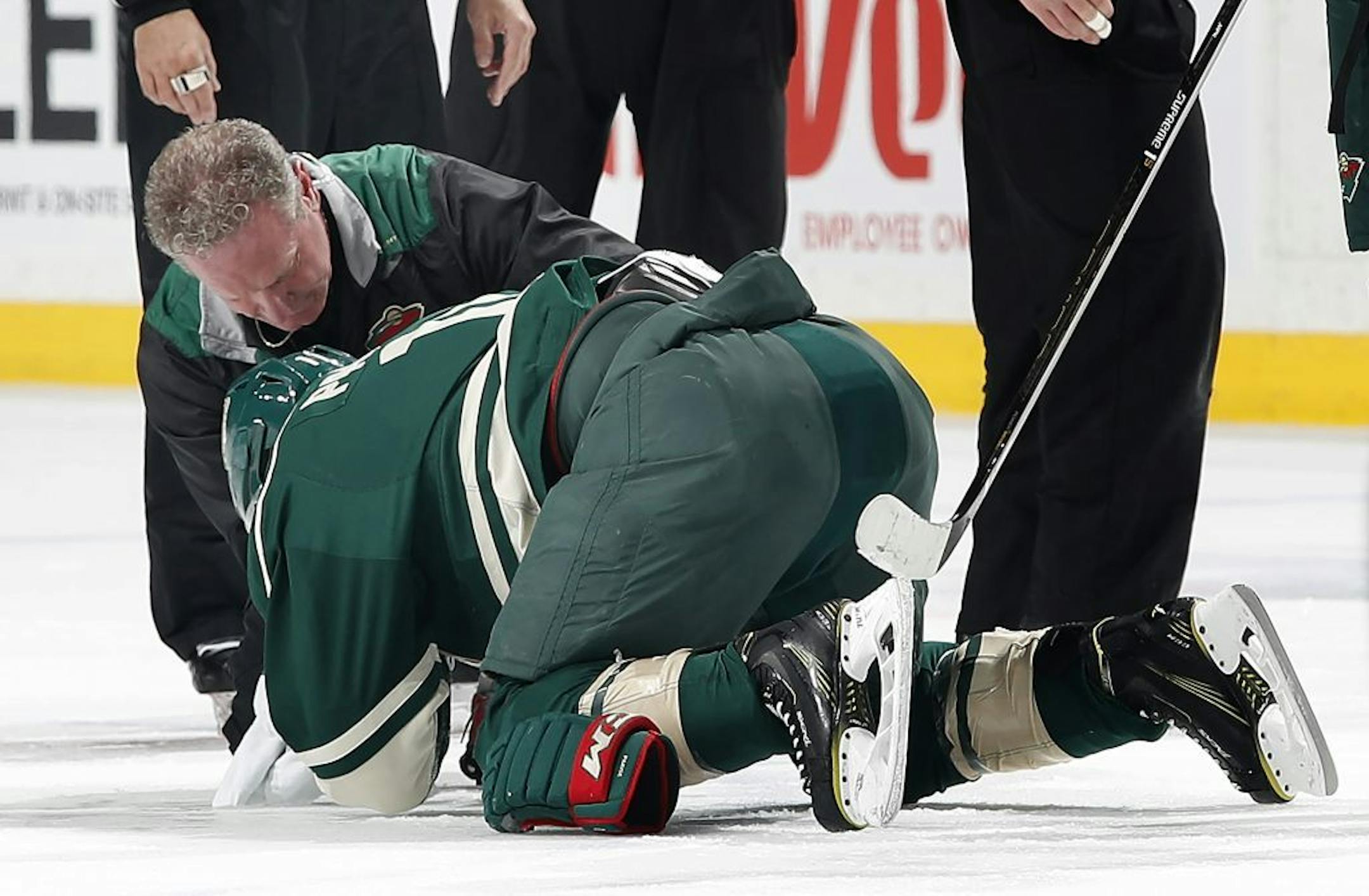 Zach Parise (11) was hit in the face with a high stick by Tom Wilson in the first period.