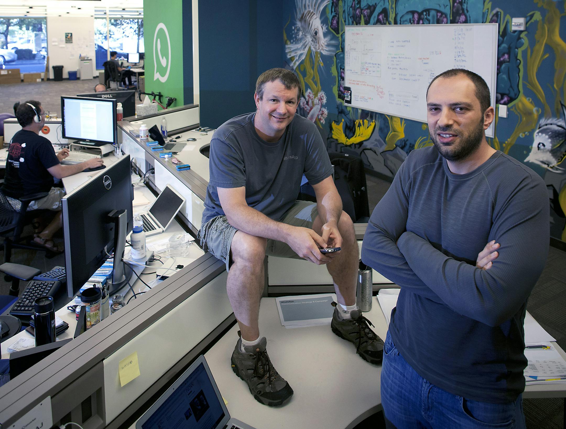 FILE -- Brian Acton, left, and Jan Koum, founders of the communicating and sharing smartphone app WhatsApp, at the company's headquarters in Mountain View, Calif., May 23, 2013. After repeatedly insisting that he wouldn‚Äôt sell his 55-person company to an ad-driven behemoth like Facebook, Google or Yahoo, Koum has now reversed course by selling the company to Facebook for at least $16 billion. (Peter DaSilva/The New York Times)