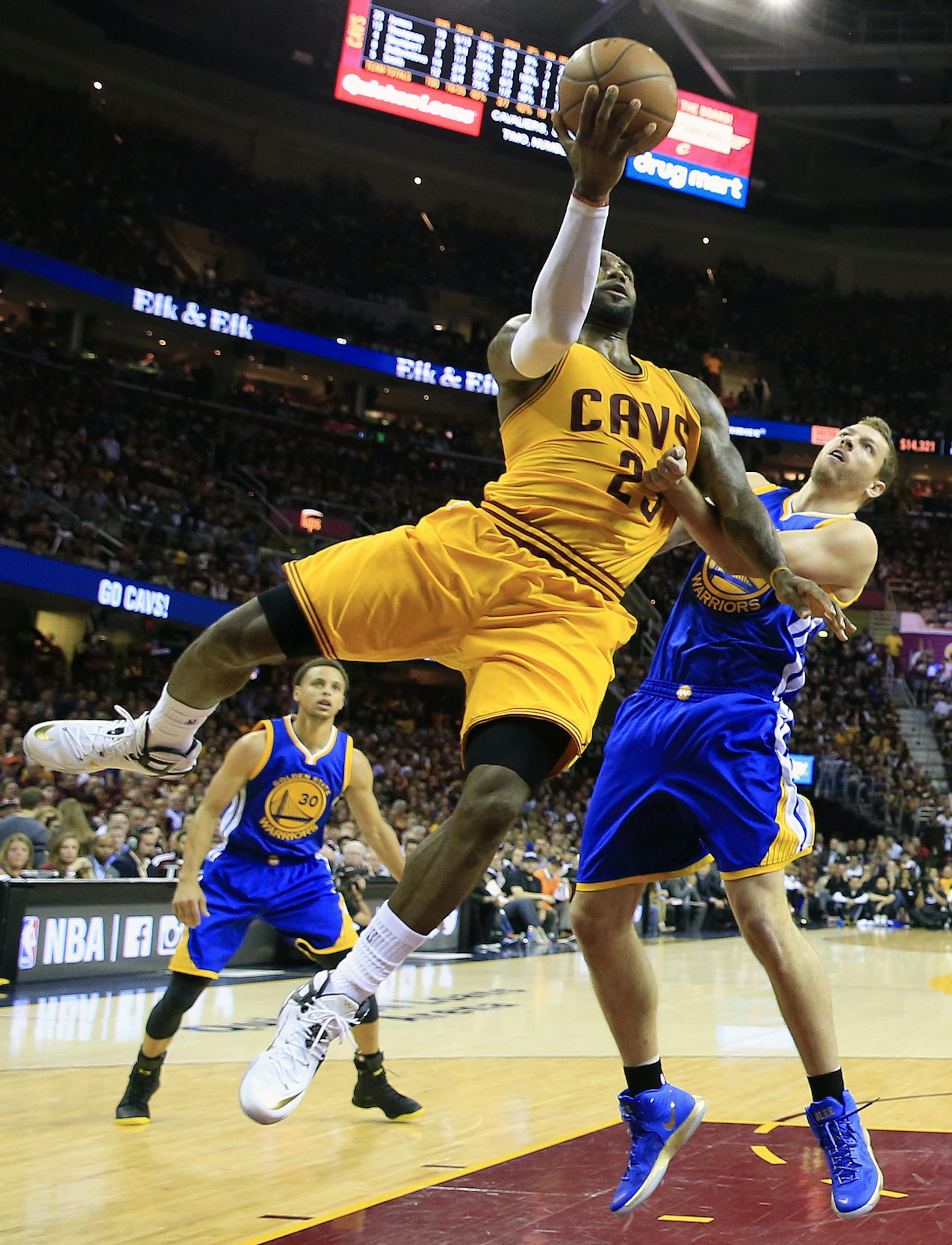Cleveland Cavaliers forward LeBron James (23) shoots over Golden State Warriors forward David Lee (10) during the first half of Game 3 of basketball's NBA Finals in Cleveland, Tuesday, June 9, 2015. (AP Photo/Mike Ehrmann/Pool Photo via AP)