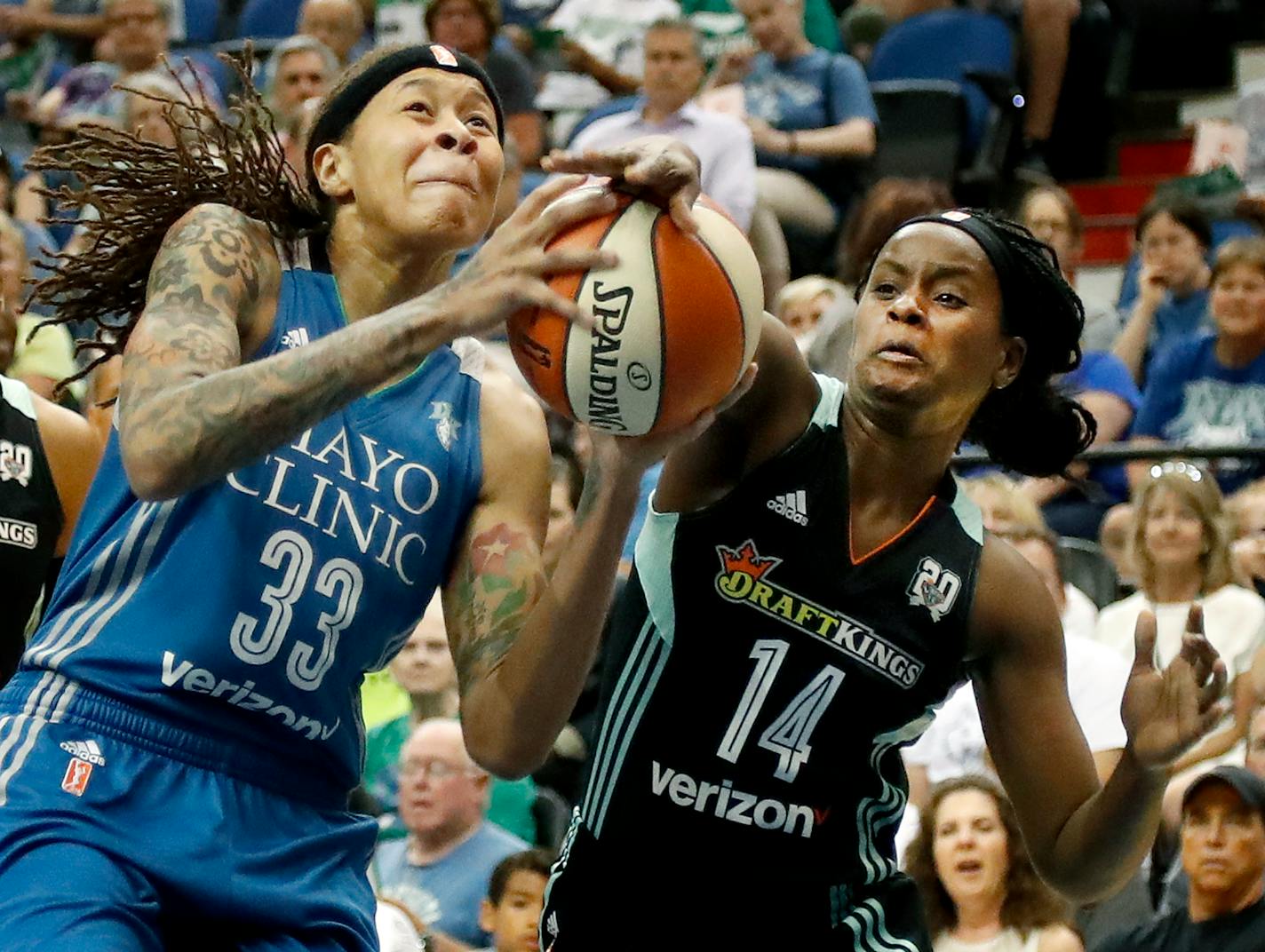 Seimone Augustus (33) was defended by Sugar Rodgers (14) in the first quarter.