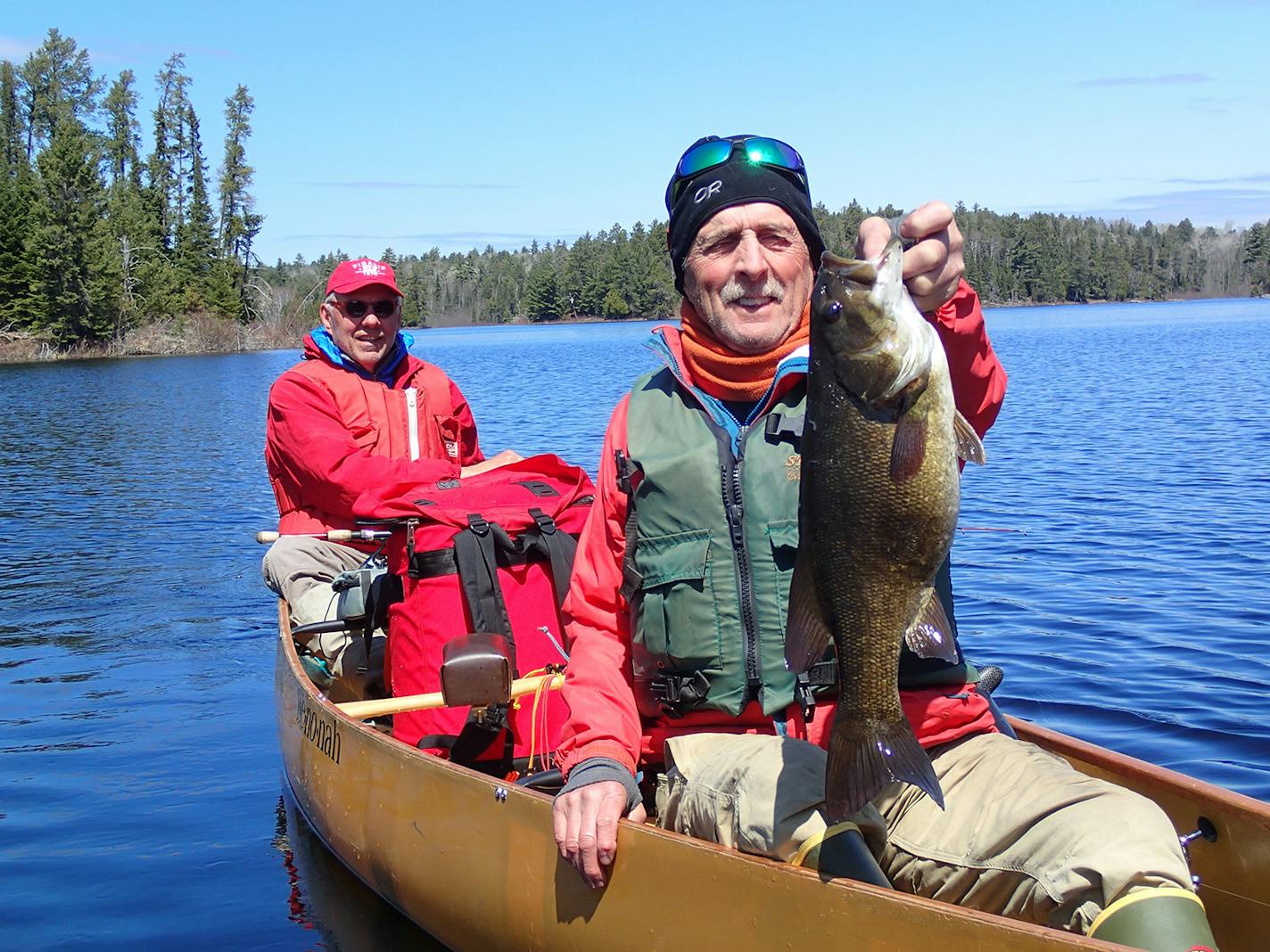 Steve Lampman of Ely held a huge small-mouth bass, which he released. He is shown with Steve Piragis, also of Ely.