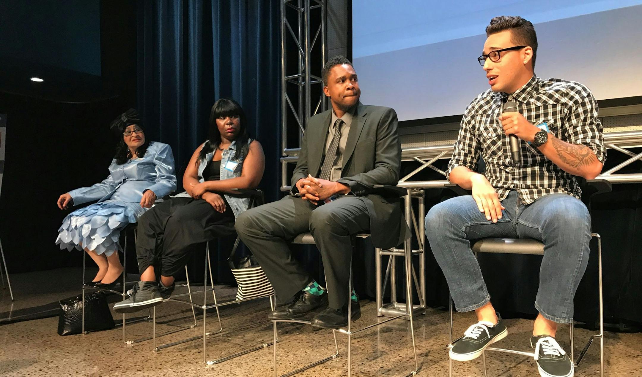 Sebastian Rivera, an organizer for Asamblea de Derechos Civiles, speaks during a panel following the screening of "Sold Out: Affordable Housing at Risk" in St. Paul Wednesday, June 7. Former tenants of Crossroads at Penn listen next to him.