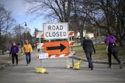Pedestrians walked around a "road closed" sign as they walked around Lake Harriet Wednesday afternoon. ] aaron.lavinsky@startribune.com Minneapolis' p
