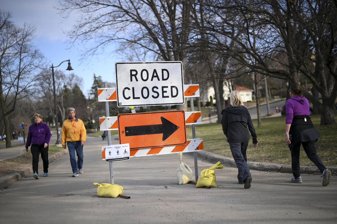 Pedestrians walked around a "road closed" sign as they walked around Lake Harriet Wednesday afternoon. ] aaron.lavinsky@startribune.com Minneapolis' parks have become a source of respite for anyone needing peace of mind during Gov. Walz's stay-at-home order to control the coronavirus outbreak. Enter the Minneapolis Park Board and Superintendent Al Bangoura. We take an inside look at how the board is making decisions to open or close parkways, how they're monitoring social distancing and why they