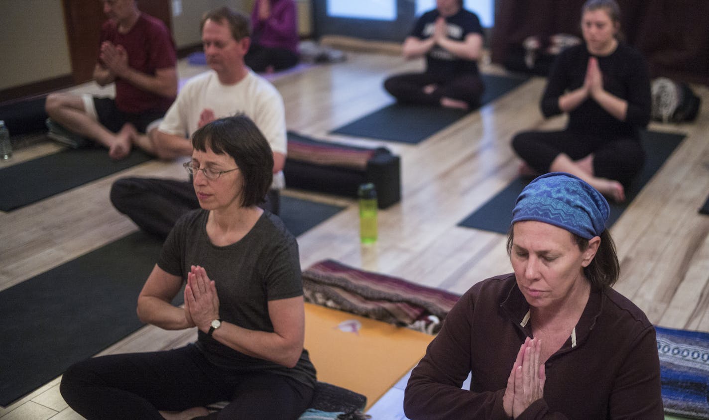 At Maureen Farley's class the Green Lotus Yoga, Kate Redpath,53, far right, practiced her poses in a class that is focused on the individual's personal progress .]Richard Tsong-Taatarii/rtsong-taatarii@startribune.com