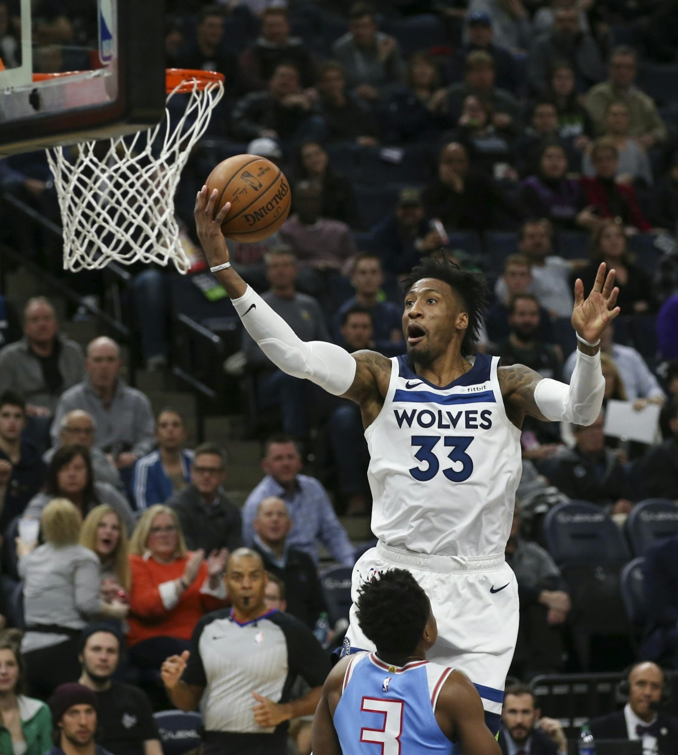 Minnesota Timberwolves forward Robert Covington (33) with a secodn half layup above Sacramento Kings guard Yogi Ferrell (3).