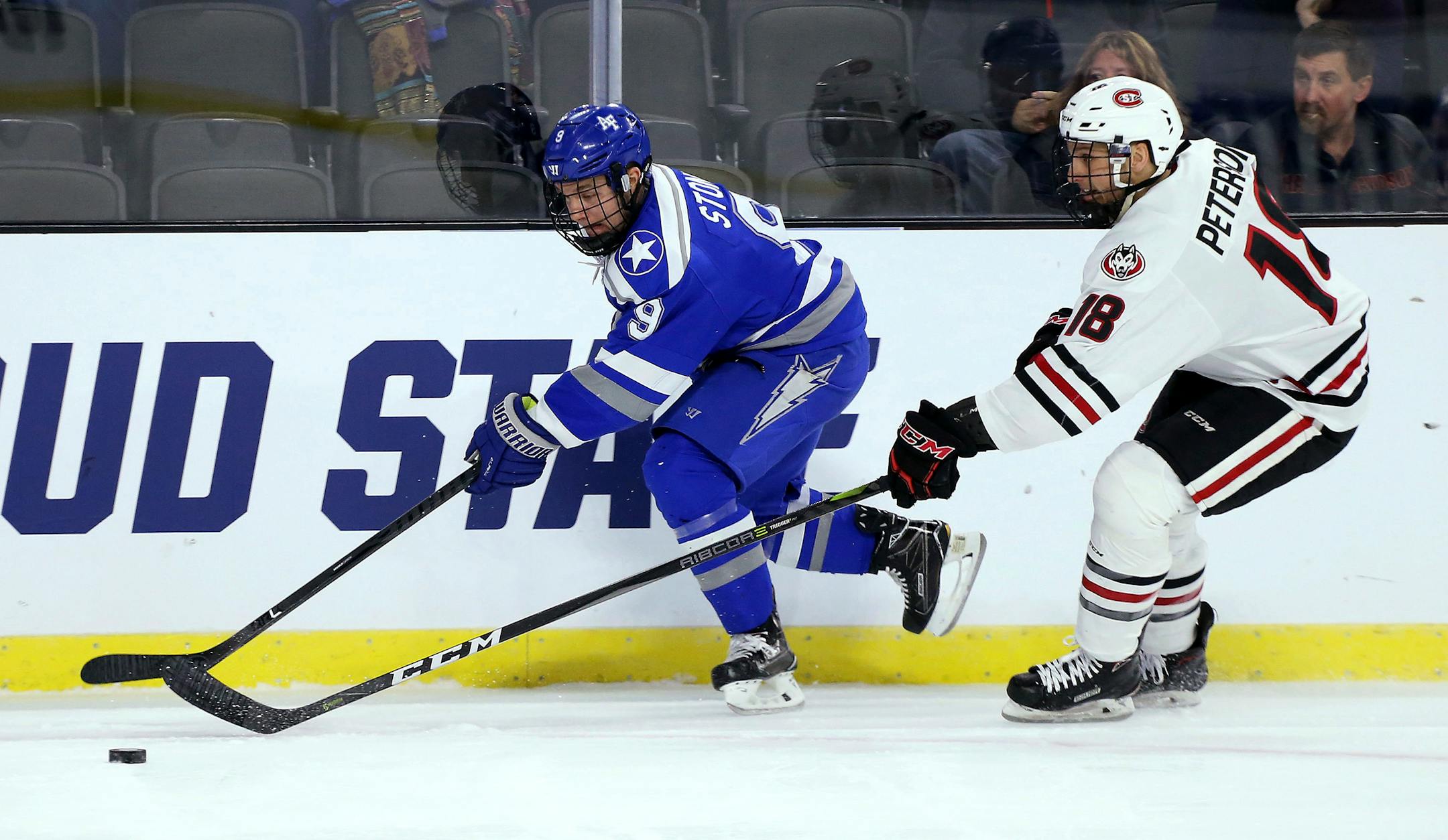 Air Force's Trevor Stone (9) controls the puck in front of St. Cloud State's Judd Peterson (18) during the first period of an NCAA regional men's college hockey tournament game, Friday, March 23, 2018, in Sioux Falls, S.D. (AP Photo/Dave Eggen)