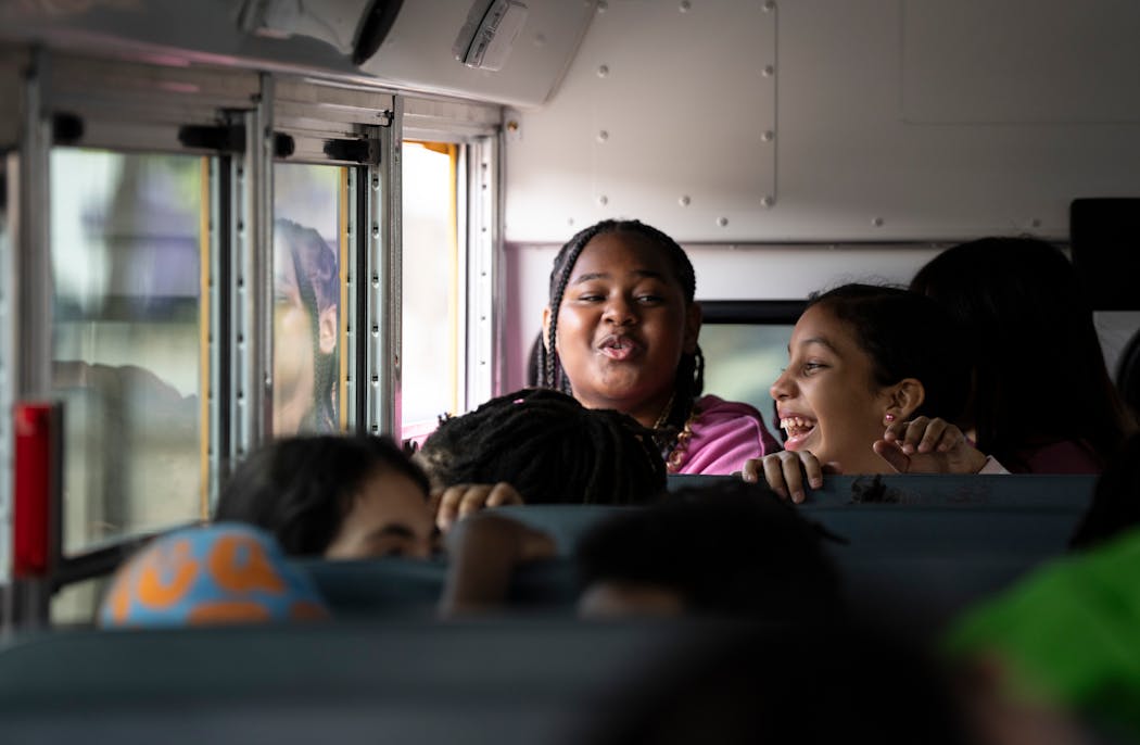 FIfth-graders from Whittier Elementary School get a ride on a new electric bus after a Minneapolis school district's Tuesday news conference announcing new electric buses.