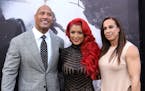 Dwayne Johnson, from left, Eva Marie and Dany Garcia arrive at the world premiere of "San Andreas" at the TCL Chinese Theatre on Tuesday, May 26, 2015