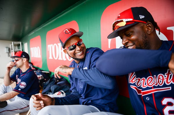 Twins starting pitcher Ervin Santana (54) and third baseman Miguel Sano (22) joked around in the dugout at spring training.