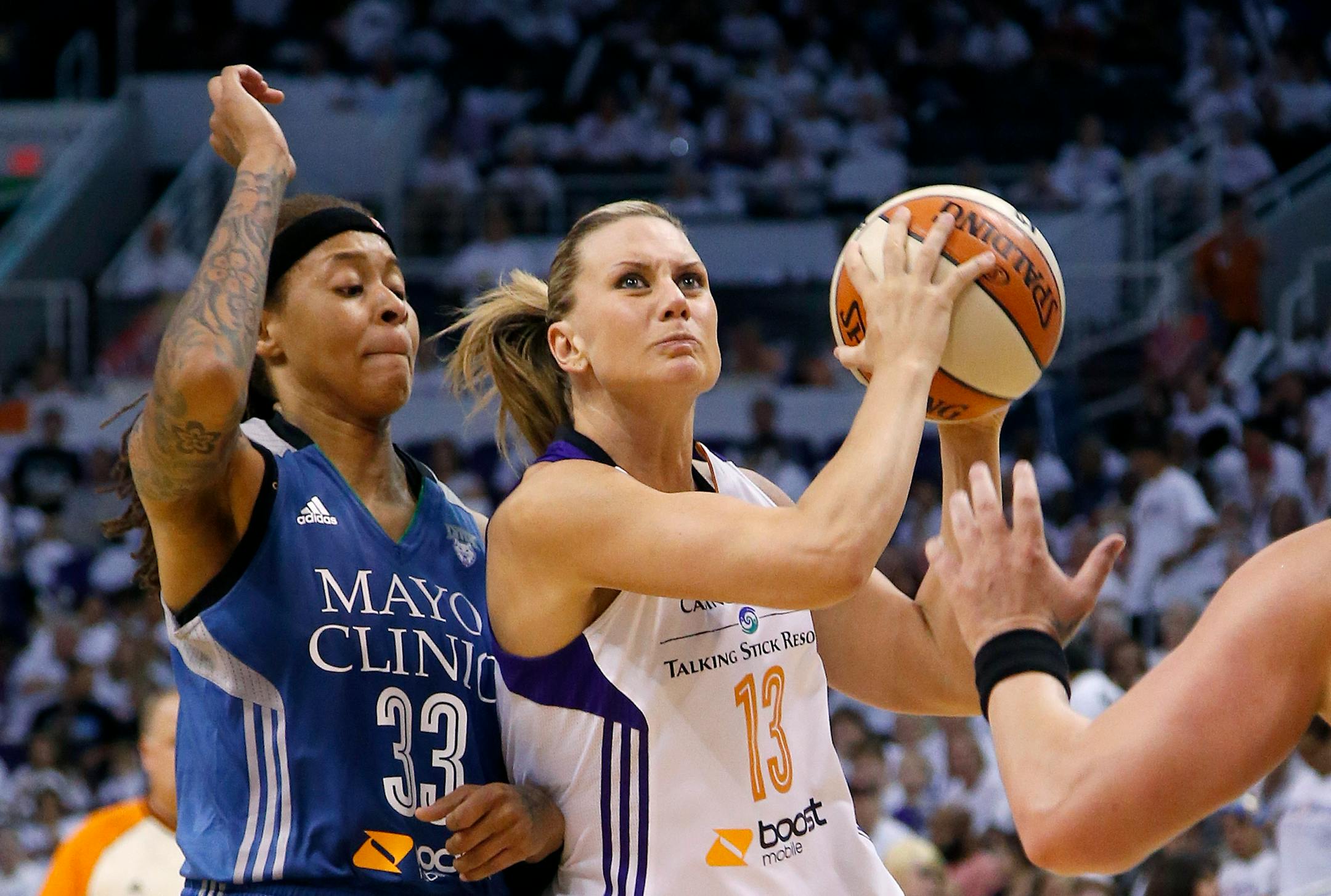 Phoenix Mercury's Penny Taylor, drives past Minnesota's Seimone Augustus during the second half in Game 1 of the WNBA basketball Western Conference finals Friday, Aug. 29, 2014, in Phoenix. The Mercury defeated the Lynx 85-71. (AP Photo/Ross D. Franklin)