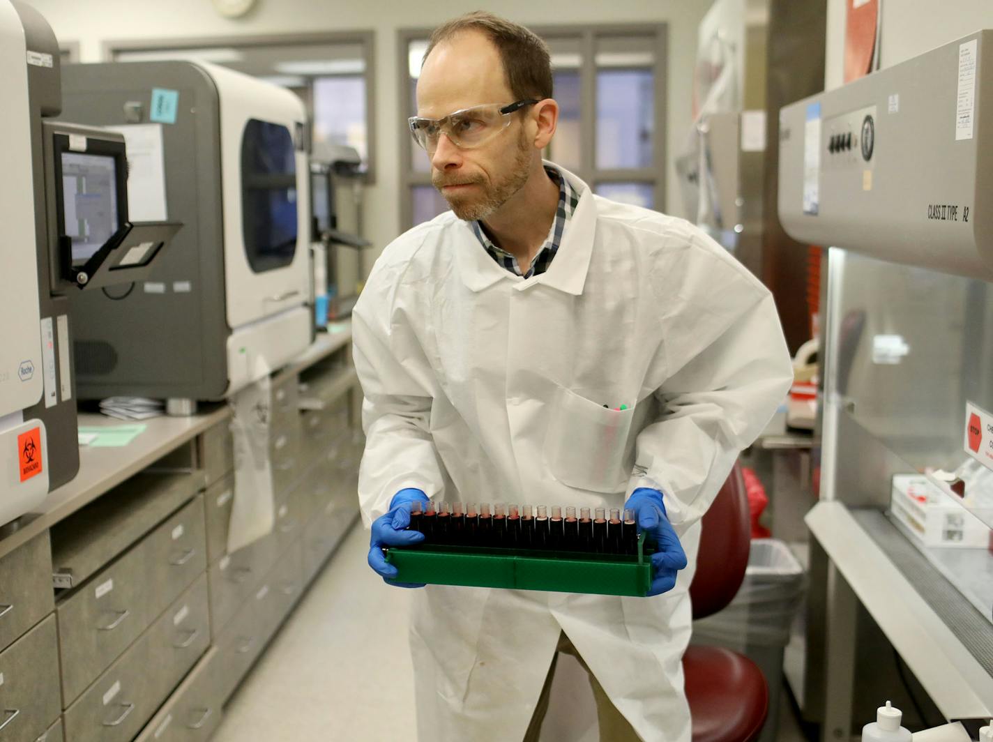 Brian Howell, a lab technologist, works on the extracting of RNA from a sample in the Mayo Clinic virology lab last week in Rochester.