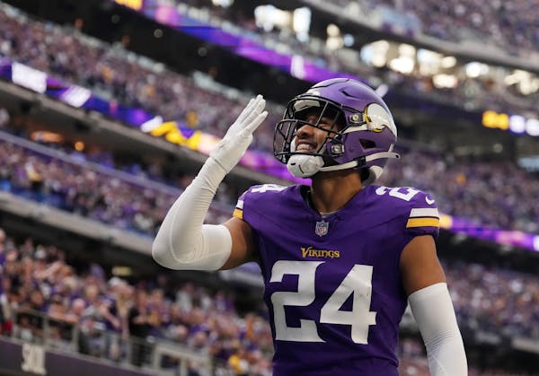 Vikings safety Camryn Bynum gestures to his wife, Lalaine, who was watching him play in person for the first time Sunday.