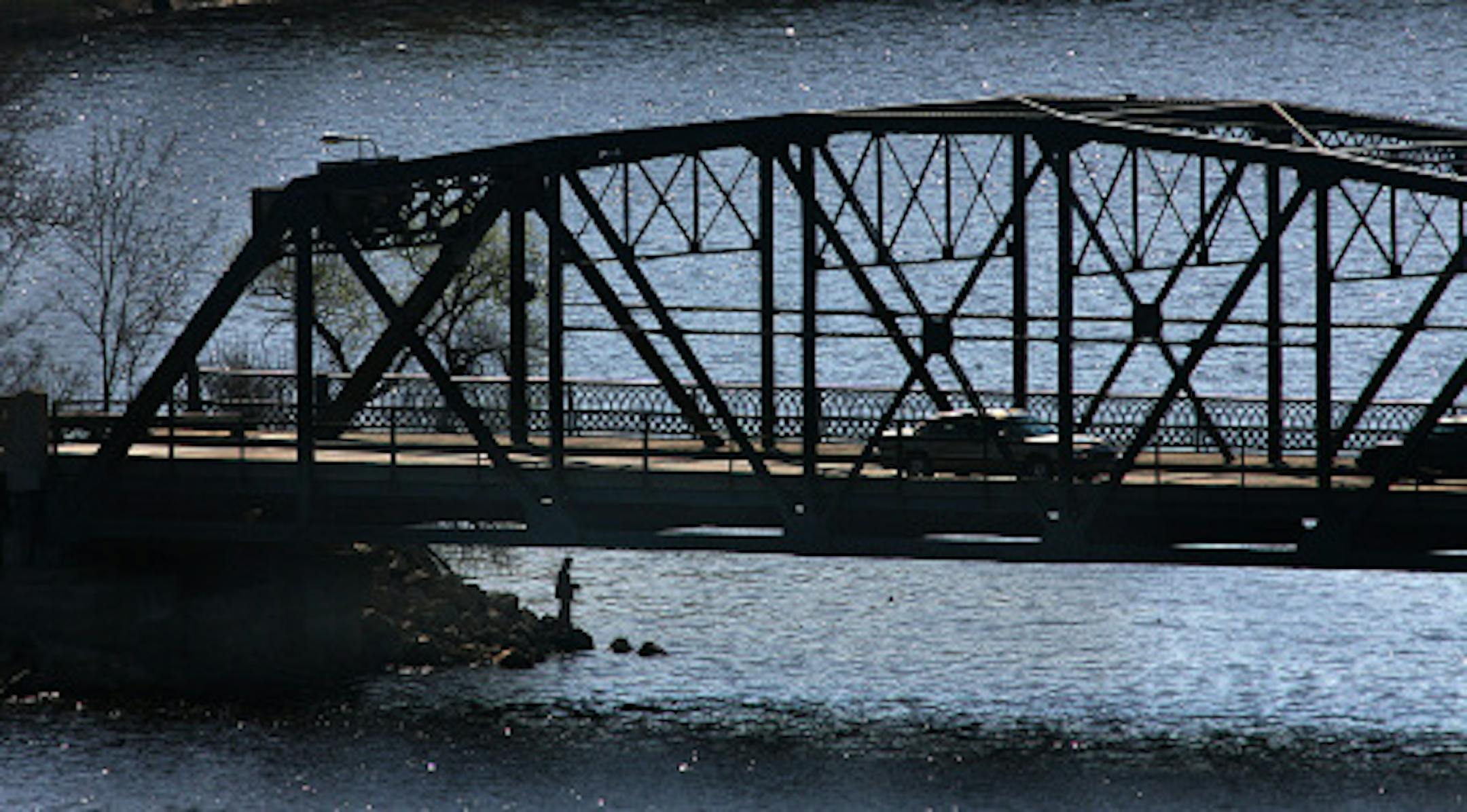 JIM GEHRZ ' jgehrz@startribune.com Stillwater/May 2, 2009/9:30AM An angler fished from shore, beneath the Stillwater lift bridge from the Wisconsin side during the St. Croix River walleye season opener Saturday, May 2, 2009. Despite breezy conditions, many others enjoyed the opener from boats all along the river.