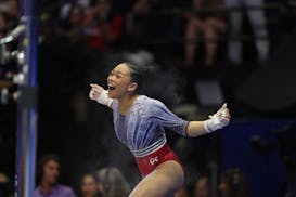 Suni Lee of St. Paul celebrates after performing on the uneven bars on Day 2 of the United States Olympic gymnastics trials at Target Center in Minnea