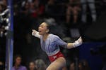 Suni Lee of St. Paul celebrates after performing on the uneven bars on Day 2 of the United States Olympic gymnastics trials at Target Center in Minnea