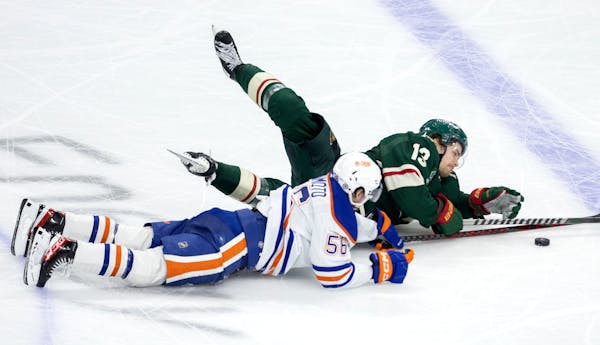 Sam Steel  of the Wild and Kailer Yamamoto (56) of the Oilers got tangled up on Monday night at Xcel Energy Center.