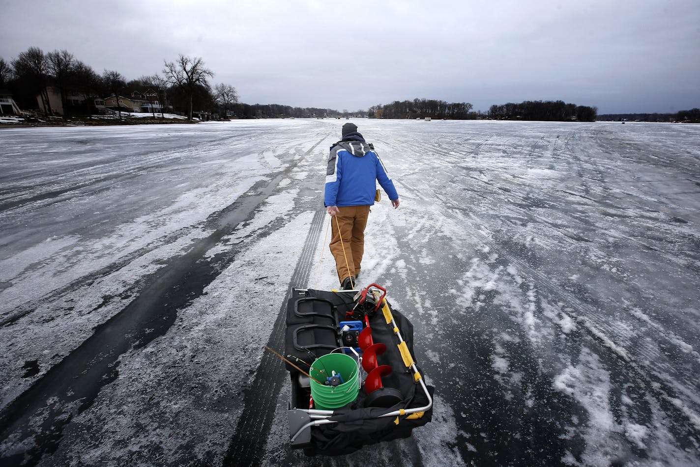 Joel Rebney, 33 of Burnsville pulled his ice fishing gear out onto Upper Prior Lake on Tuesday afternoon. ] CARLOS GONZALEZ cgonzalez@startribune.com, January 27, 2015, Prior Lake, Minn., Outdoors Weekend story is about south metro and south-state ice fishing