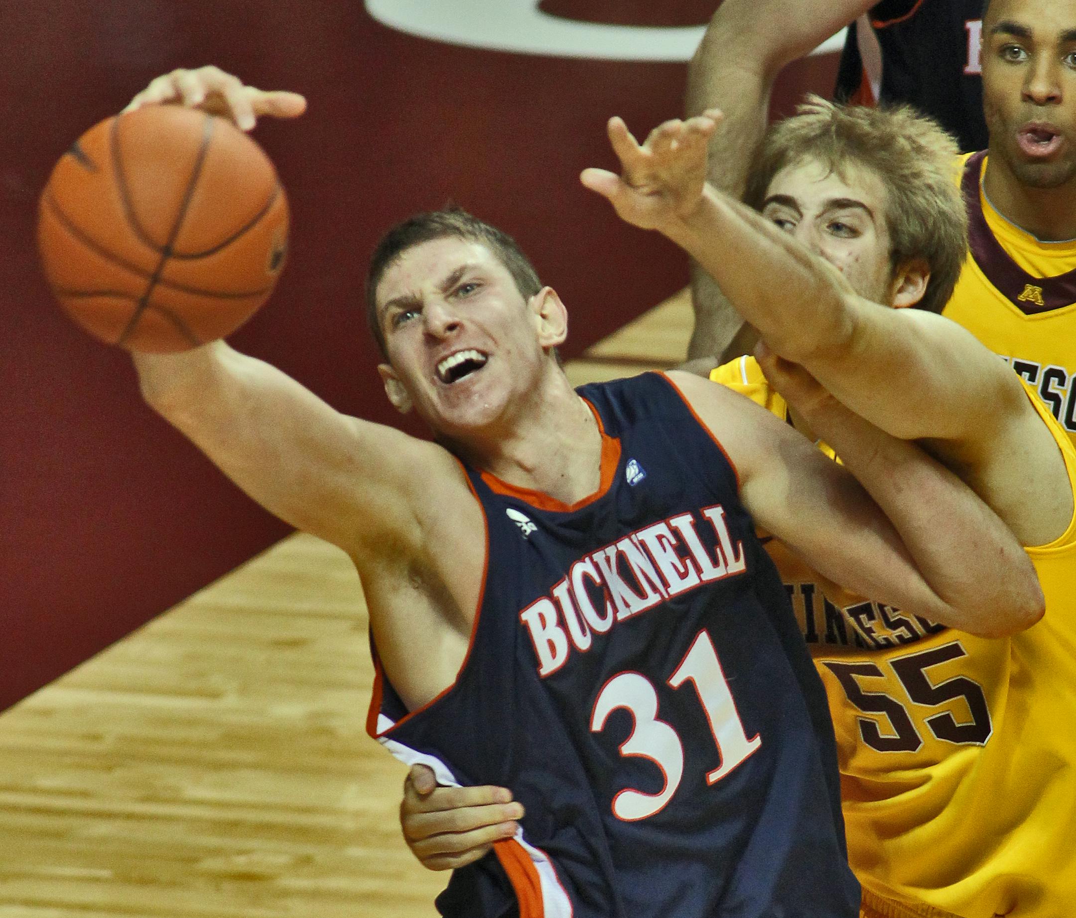 Mike Muscala grabbed a rebound away from the Gophers' Elliott Eliason during a game last season. Muscala could be a first-round NBA pick.