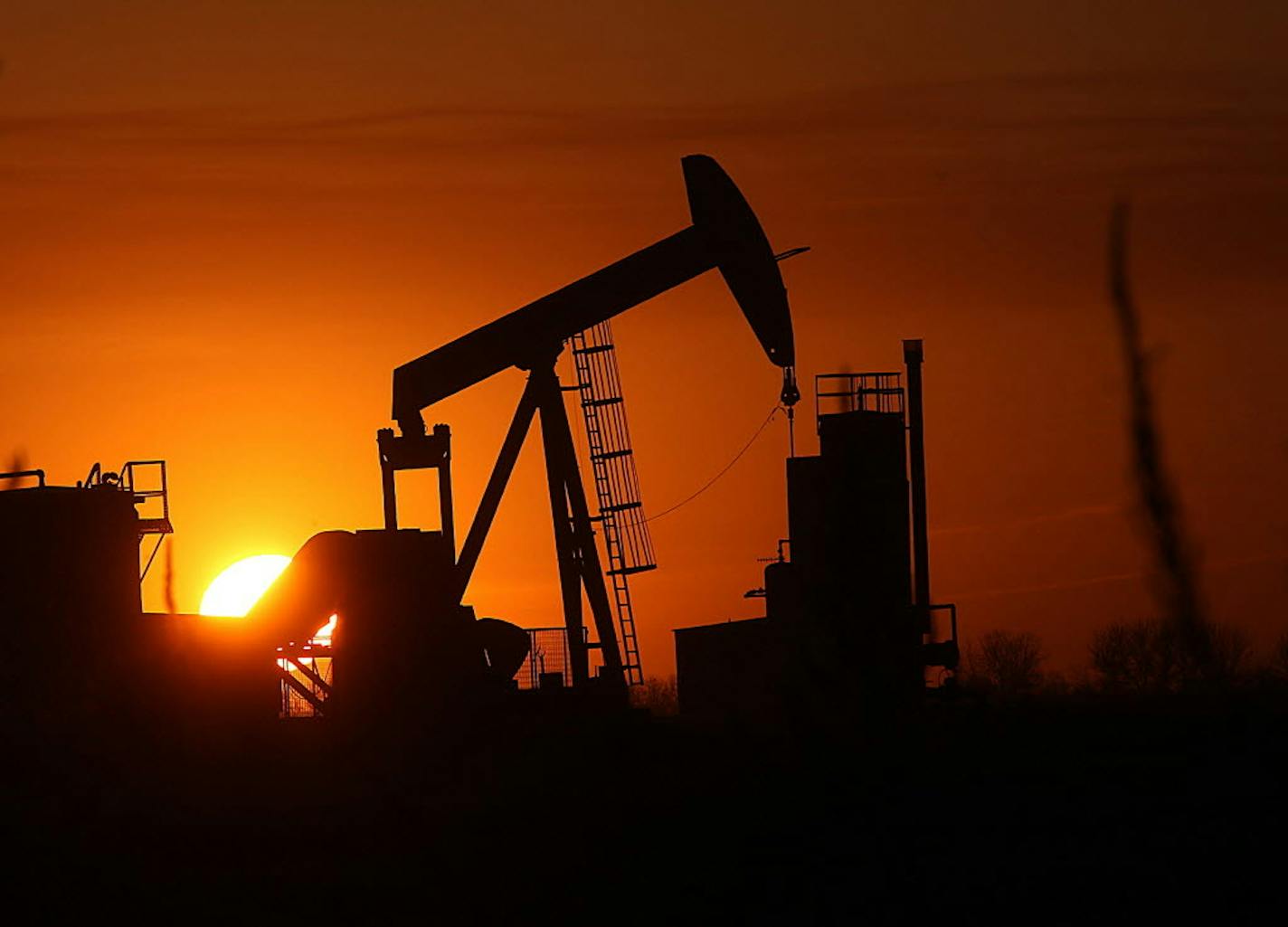 The sun sets behind an oil pump in Williston, N.D., where Mercy Medical Center delivered 882 babies in 2015 — up from 804 in 2014.