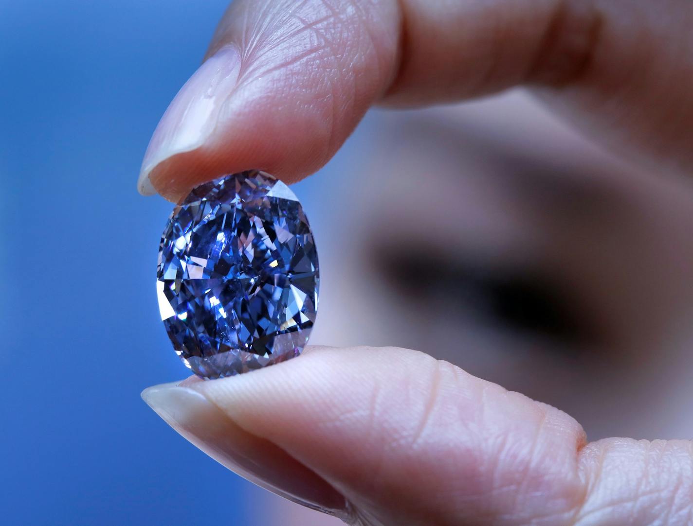 A model displays a rare 10.10-carat blue diamond during an exhibition by Sotheby's auction house in Hong Kong, Monday, March 22, 2016. The oval-shaped, "Internally Flawless Fancy Vivid" blue diamond, estimated to be worth between US$30 to 35 million, is part of the De Beers Millennium collection and will be on auction in Hong Kong early April, 2016.(AP Photo/Vincent Yu) ORG XMIT: XVY103