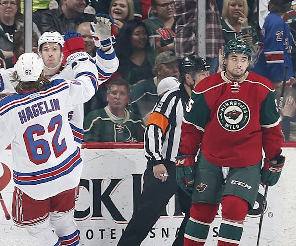 Matt Dumba (55) skated away as Rangers Dominic Moore (28) celebrated with Carl Hagelin (62) after scoring a goal in the first period.