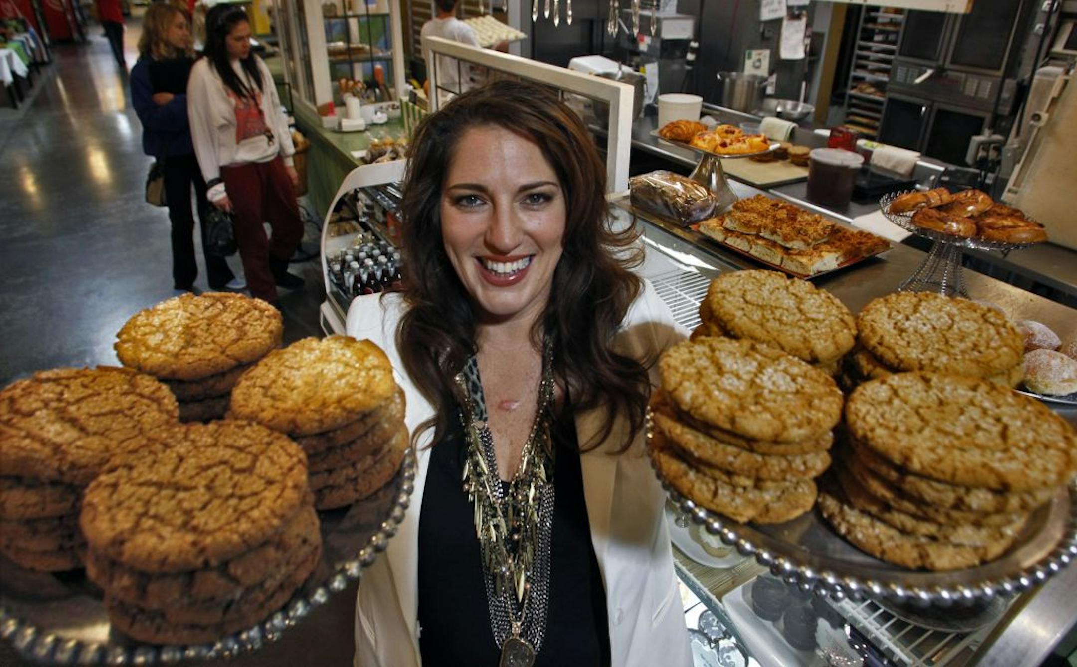 Salty Tart owner Michelle Gayer hoisted peanut butter cookies at her Midtown Market bakery. Somehow, she manages to avoid temptation.