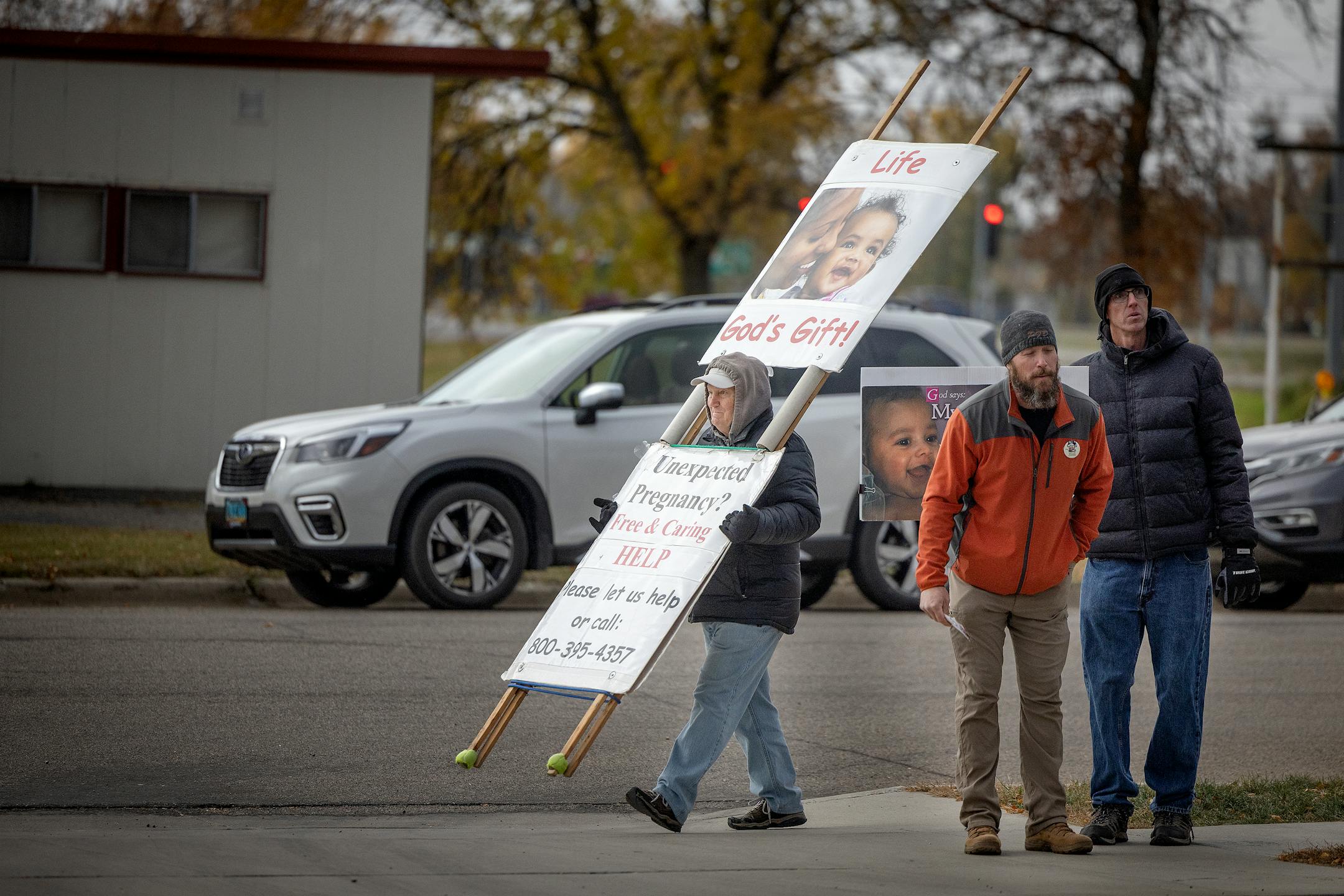 Abortion opponents prayed and stood outside the Red River Women's Clinic in Moorhead.