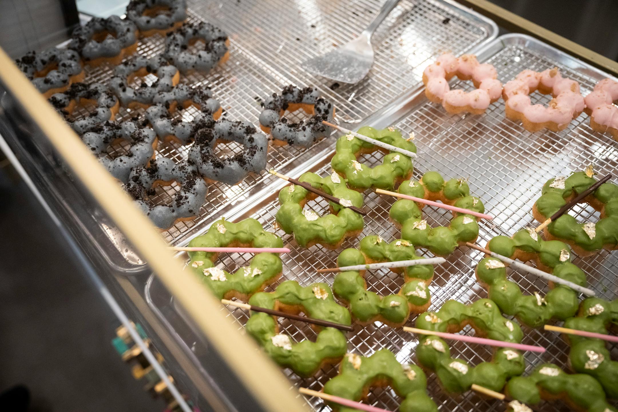 There was a consistently long line at Mochi Dough for doughnuts like the golden macha at a soft opening for the new Asia Mall.
