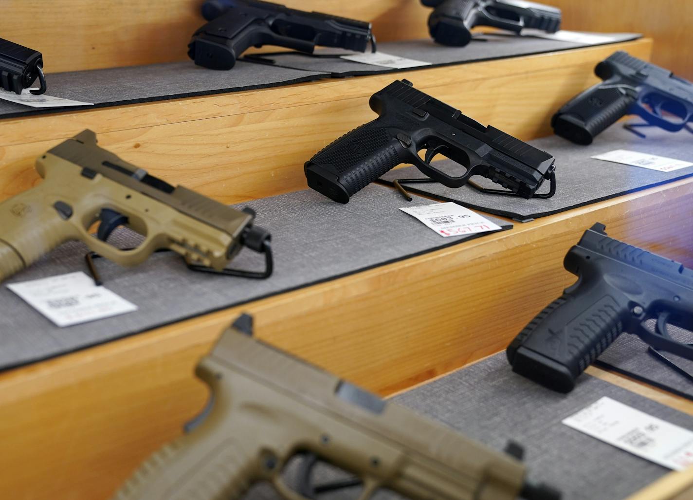 Handguns for sale sat behind glass in cases at the Stock & Barrel Gun Club Wednesday afternoon. ] ANTHONY SOUFFLE • anthony.souffle@startribune.com Customers fired guns on the shooting rage at the Stock & Barrel Gun Club Wednesday, Sept. 2, 2020 in Chanhassen, Minn. Customers are buying up guns and ammunition in droves, motivated by the COVID-19 pandemic and the riots following the George Floyd killing, leaving a significant shortage of both items. Factories that make guns and bullets aren't ope