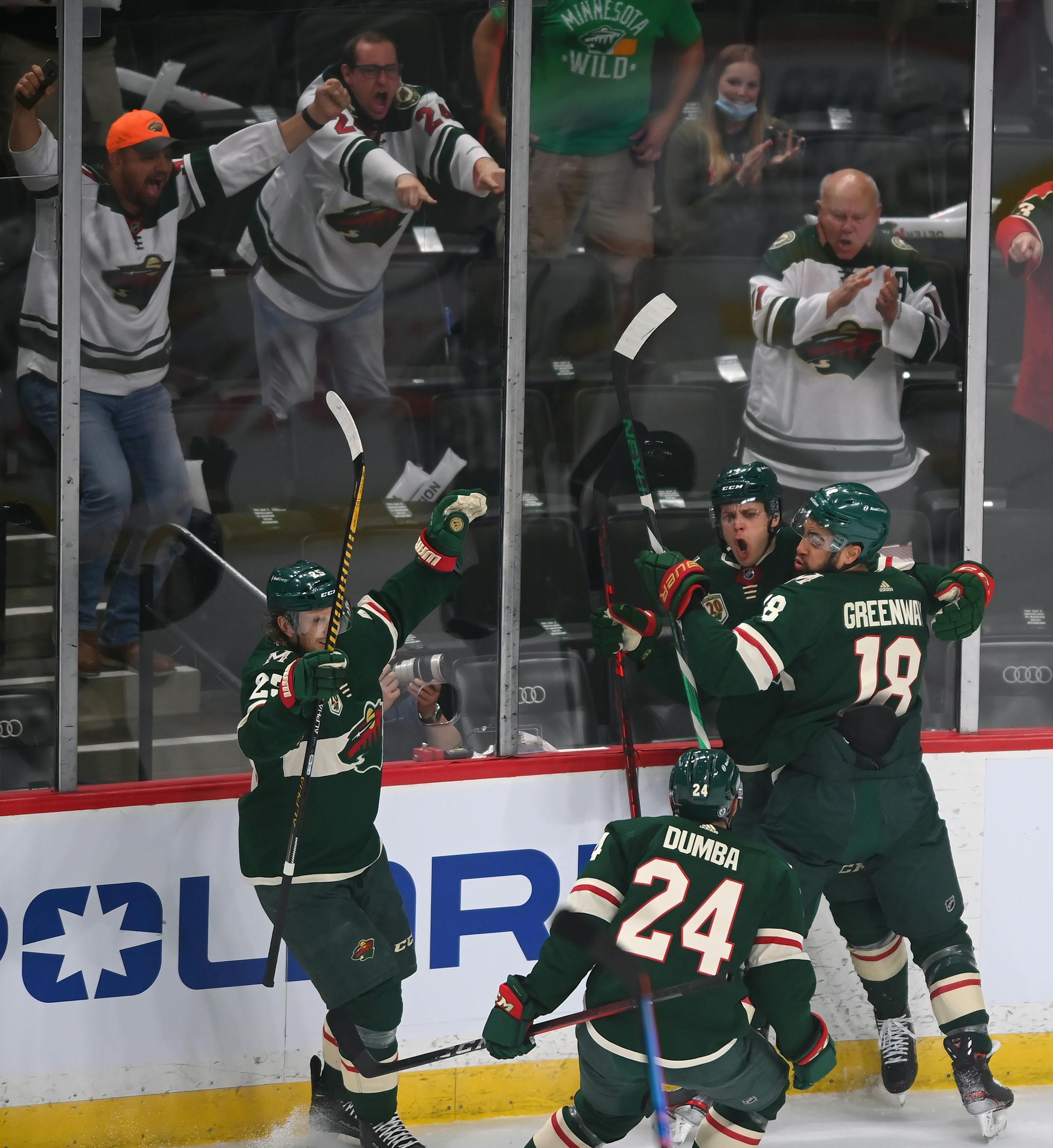 Minnesota Wild center Joel Eriksson Ek, middle against glass, reacts after scoring the second goal in the first period with teammates Minnesota Wild left wing Jordan Greenway (18), Minnesota Wild defenseman Matt Dumba (24) and Minnesota Wild defenseman Jonas Brodin (25).
