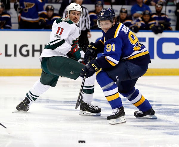 The Wild's Zach Parise (11) and the Blues' Vladimir Tarasenko battled over a loose puck during the second period in Game 3 Sunday.