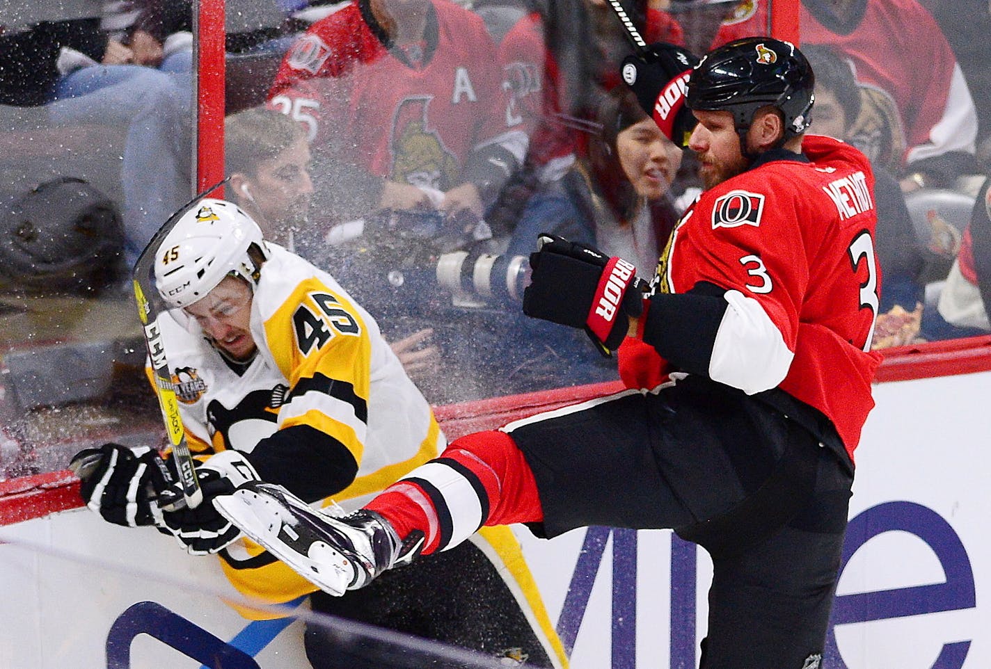 Pittsburgh Penguins right wing Josh Archibald (45) is checked by Ottawa Senators defenseman Marc Methot (3) during the first period of Game 4 of the NHL hockey Stanley Cup Eastern Conference finals, Friday, May 19, 2017, in Ottawa, Ontario. (Sean Kilpatrick/The Canadian Press via AP)