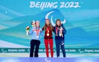 Gold medalist Natalie Wilkie, of Canada, center, poses with silver medalist Vilde Nilsen, of Norway, left, and bronze medalist Sydney Peterson, of Lak