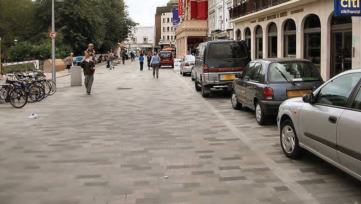 This is an example of a woonerf, which is a space oriented toward pedestrians and bikers, but also open to low-speed motor traffic, primarily for parking