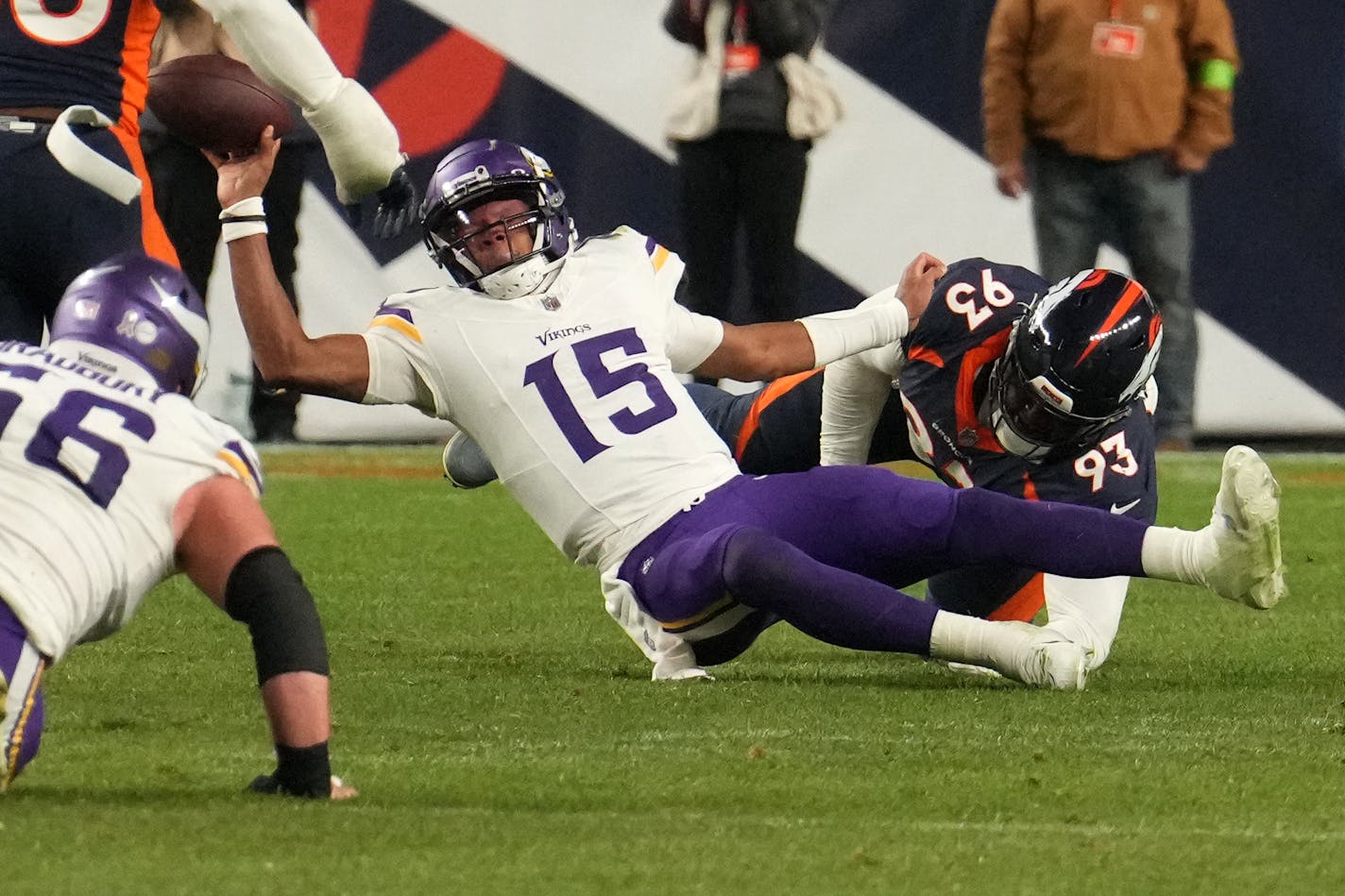 Minnesota Vikings quarterback Joshua Dobbs (15) is stopped by Denver Broncos defensive tackle D.J. Jones (93) as he scrambles out of the pocket late in the fourth quarter of an NFL game between the Minnesota Vikings and the Denver Broncos Sunday, Nov. 19, 2023 at Empower Field at Mile High in Denver.. ] ANTHONY SOUFFLE • anthony.souffle@startribune.com