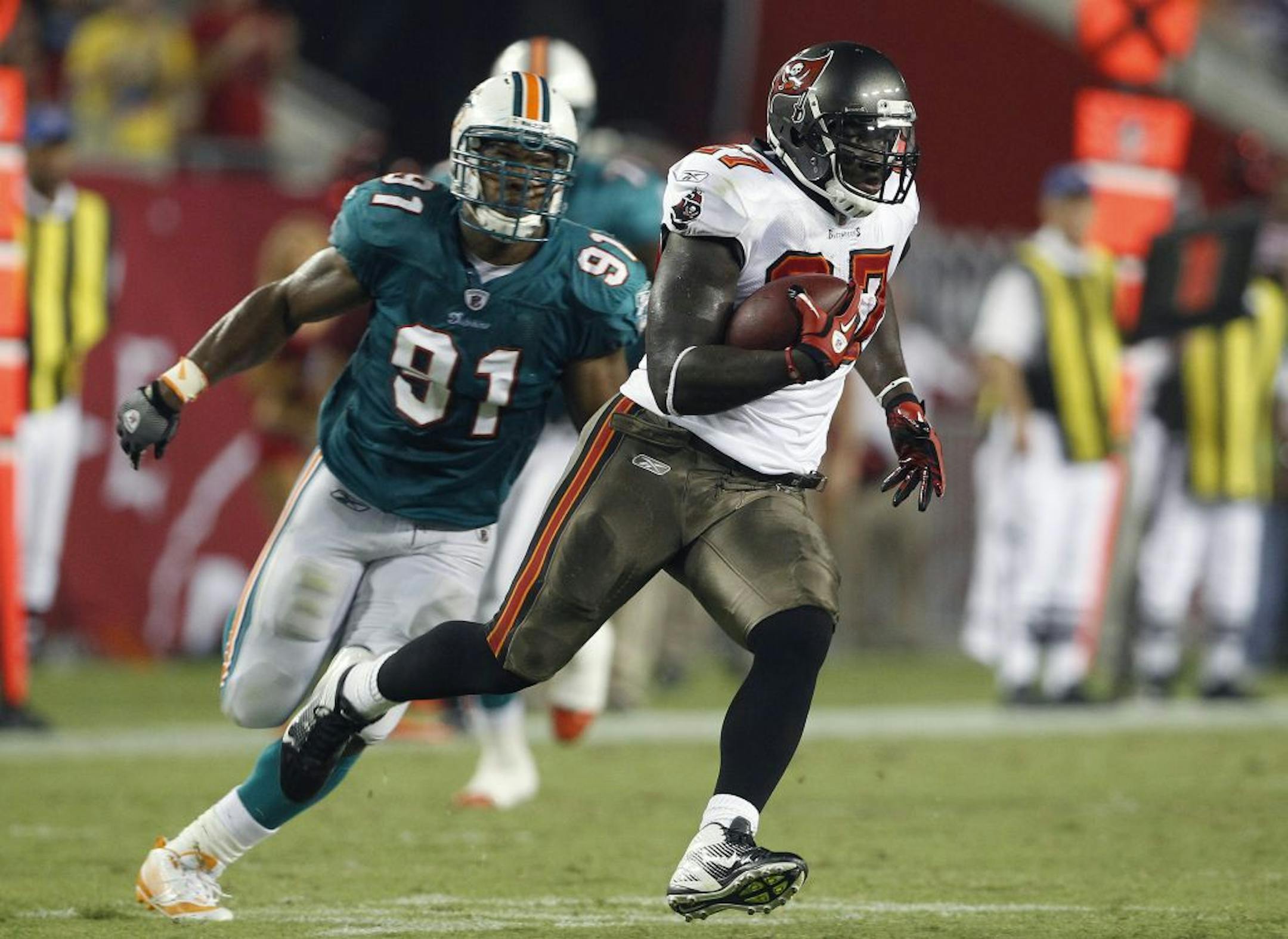 Tampa Bay Buccaneers running back LeGarrette Blount (27) outraces Miami Dolphins linebacker Cameron Wake (91) up the field during the second half of a preseason NFL football game Saturday, Aug. 27, 2011, in Tampa, Fla.