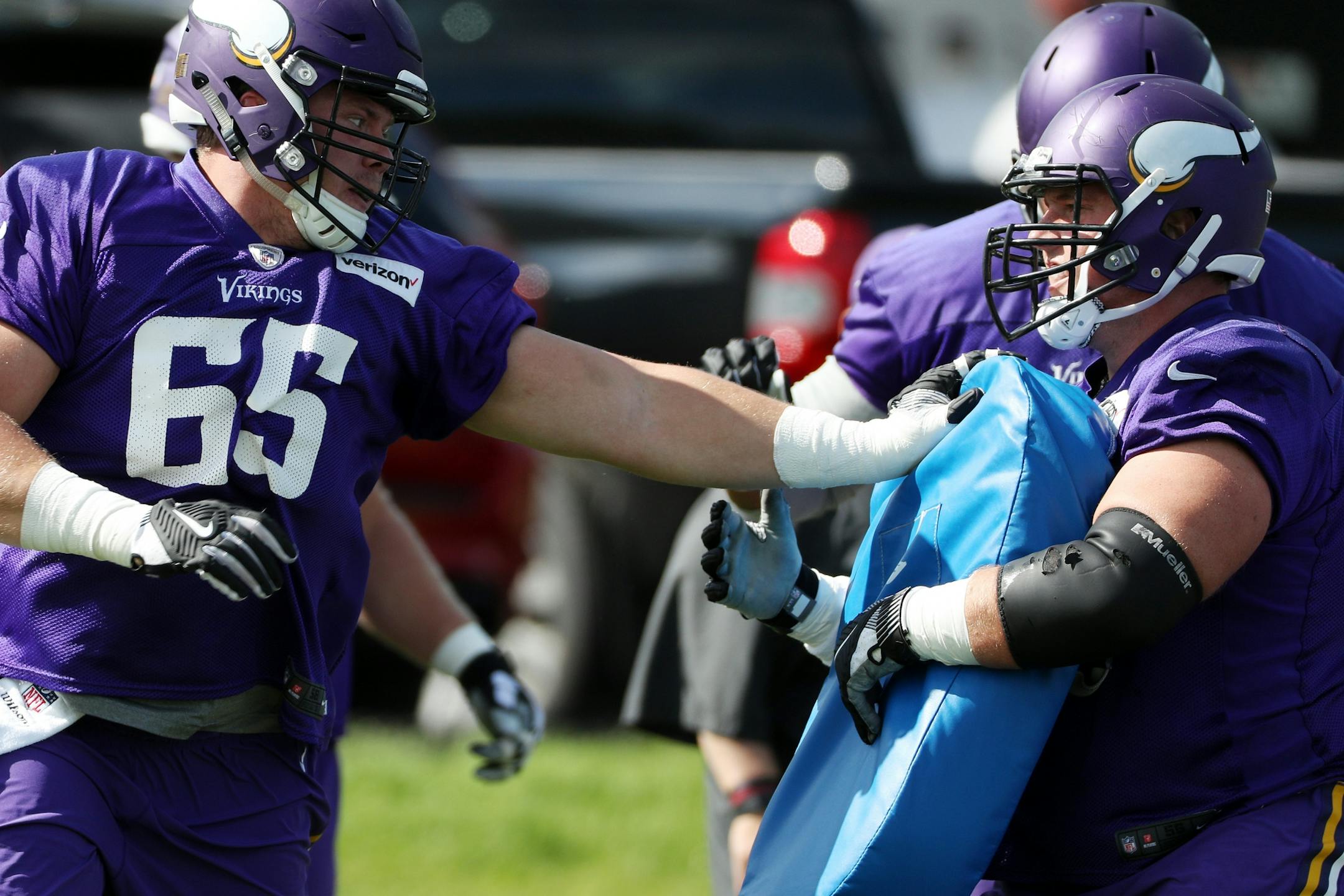 Minnesota Vikings center Pat Elflein (65) tackled a bag held by Minnesota Vikings center Nick Easton (62) during practice Tuesday.