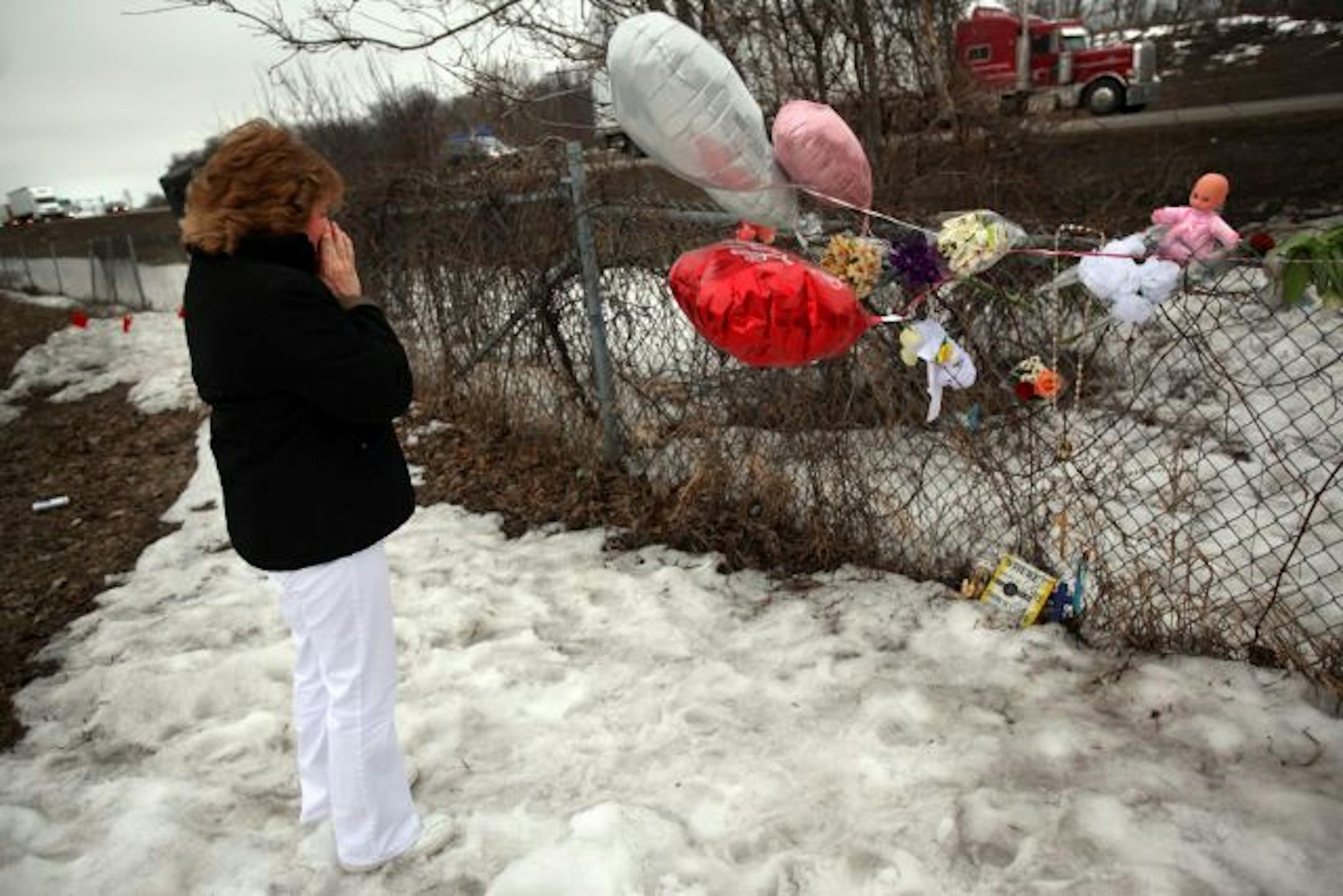 Marietta McGaha fought to hold back tears at a memorial set up on a fence along I-35W near where 6-year-old Kallie Palmer died last week. Kallie climbed over the fence and was killed when she ran onto the freeway. McGaha works in food service at Kallie's school and has fond memories of her smiling face in the lunch line.
