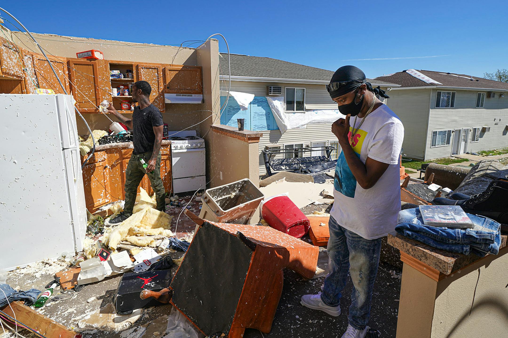 Andre Moren, right, and his cousin Dennis Muhammad looked over what was left of their belongings from their second floor apartment.