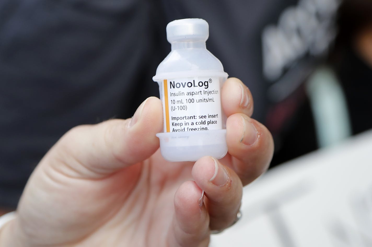 A patient holds a vial of insulin during a news conference outside a Windor, Ont. pharmacy on July 28, 2019. (AP Photo/Carlos Osorio) ORG XMIT: MERed13ea4854232ab4cfade8b44a36a