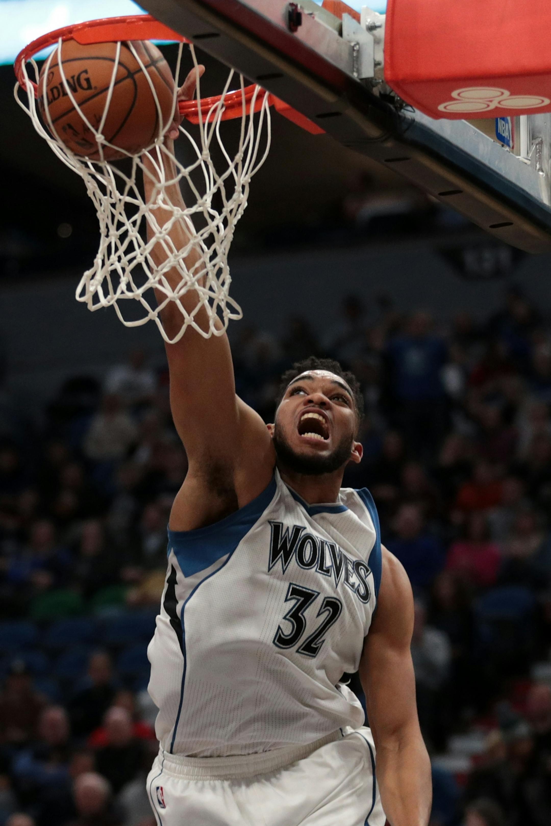 Minnesota Timberwolves center Karl-Anthony Towns (32) dunks the ball in the first half.