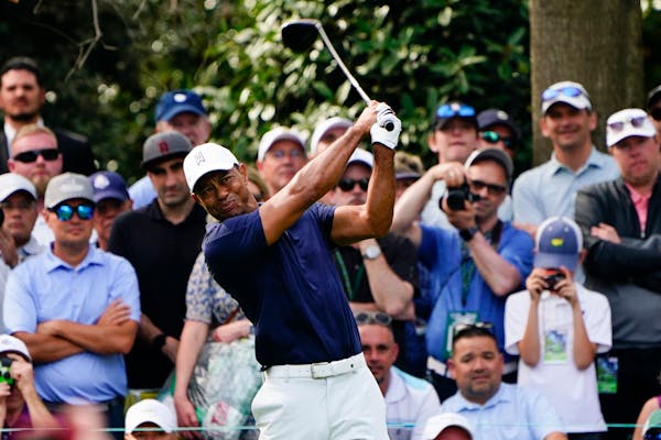 Tiger Woods tees off on the seventh hole Monday during a practice round for the Masters.