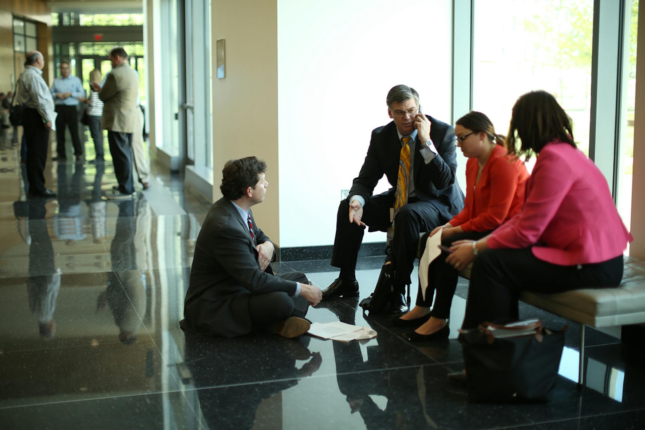 With both the House and Senate in recess Sunday afternoon, Rep. Dennis Smith, R-Maple Grove, on floor, Sen. Eric Pratt, R-Prior Lake, and House Majority Leader Joyce Peppin, R-Rogers, right, and an unidentified staffer confered in the Senate Building Sunday afternoon. ] JEFF WHEELER ï jeff.wheeler@startribune Legislators worked Sunday to agree on spending, tax cuts, and borrowing ahead of their midnight adjournment deadline Sunday, May 22, 2016.
