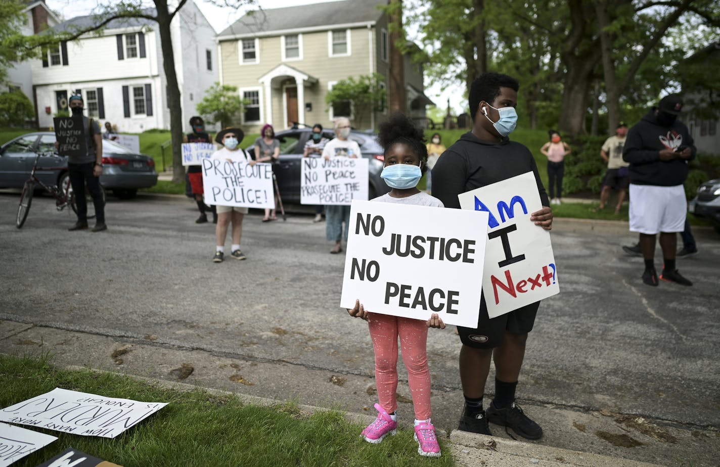 Deshawn Williams, 15, stood with his sister, Sarah Newell, 7, while protesting outside Hennepin County Attorney Mike Freeman's home in Minneapolis. "I'm 15, people younger than me get killed by police," said Williams. "I don't know if I'm next or not." ] aaron.lavinsky@startribune.com A protest was held outside the home of Hennepin County Attorney Mike Freeman's home on Wednesday, May 27, 2020 in Minneapolis, Minn. Mayor Jacob Frey on Wednesday called for an arrest and charges against the now-fi