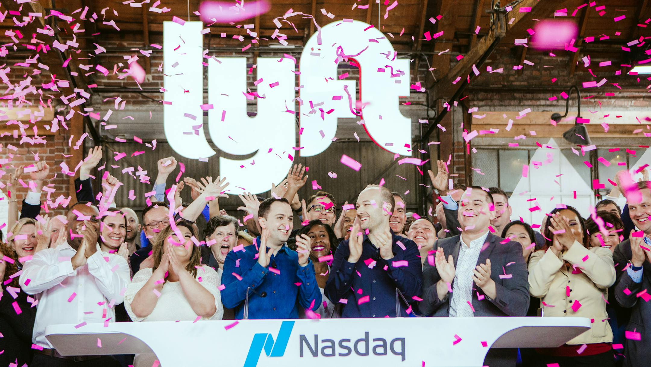 Lyft co-founders John Zimmer, center left, and Logan Green, center right, at the company’s IPO party on Friday morning, March 29, 2019, in Los Angeles. With its initial offering, Lyft leapt ahead of Uber to became the first publicly traded ride-hailing firm. (Alex Welsh/The New York Times)